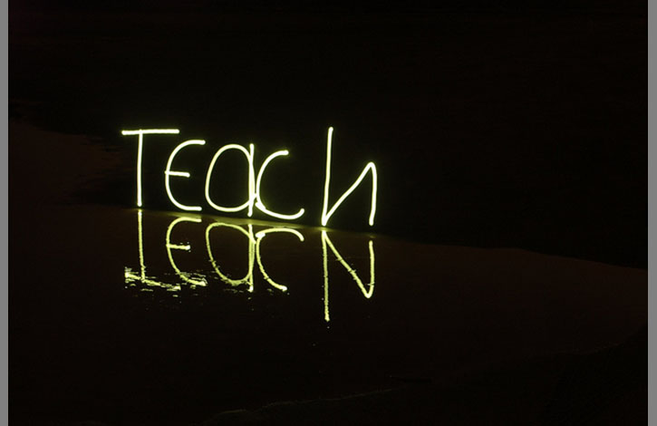 Teach scrawled in neon lights.